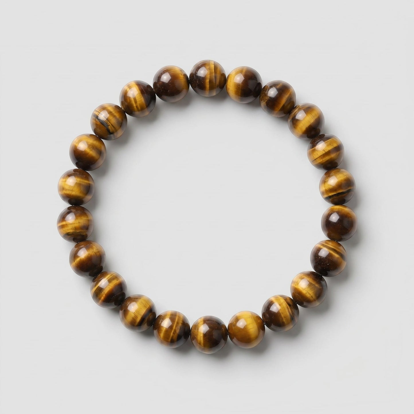 Beaded bracelet with tiger eye pattern on a light gray background